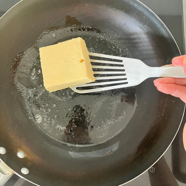 adding the shokupan french toast into the pan